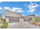 Stunning modern home boasts a three-car garage and a beautifully paved driveway, enhancing its curb appeal at 818 Calluna St, Las Vegas, NV 89138