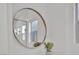 Round mirror reflecting a shower with glass door and a window with greenery at 818 Calluna St, Las Vegas, NV 89138