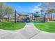 Serene community playground with shaded seating, modern play structures and lush green landscaping for Gathering enjoyment at 818 Calluna St, Las Vegas, NV 89138