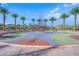 Modern playground featuring rope climbing and palm trees, ideal for children and families, with beautiful mountain views at 818 Calluna St, Las Vegas, NV 89138