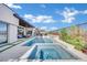 Beautiful backyard pool with spa, waterfall features, and elegant outdoor design at 818 Calluna St, Las Vegas, NV 89138