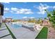 Backyard with a pool, spa, waterfall features and a covered outdoor dining area at 818 Calluna St, Las Vegas, NV 89138
