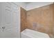 Bathroom featuring tiled walls and floors, with white door and bathtub at 900 Heavenly Hills Ct # 114, Las Vegas, NV 89145