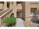 Exterior building view showcasing stucco walls, desert landscaping, and an open entryway at 900 Heavenly Hills Ct # 114, Las Vegas, NV 89145