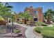 Condo exterior with palm trees, landscaping, and a walkway leading to the building entrance at 900 Heavenly Hills Ct # 114, Las Vegas, NV 89145
