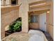 Condo exterior featuring an entry door, landscaped garden, and textured exterior wall at 900 Heavenly Hills Ct # 114, Las Vegas, NV 89145