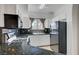 Well-lit kitchen featuring granite counters, white cabinetry, and black appliances at 900 Heavenly Hills Ct # 114, Las Vegas, NV 89145