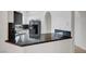 Kitchen featuring black appliances, marble countertops, white cabinets, and open layout at 900 Heavenly Hills Ct # 114, Las Vegas, NV 89145