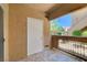 Open-air patio with tiled flooring and view of palm trees beyond railing at 900 Heavenly Hills Ct # 114, Las Vegas, NV 89145