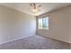 Neutral bedroom featuring plush carpet, ceiling fan, and natural light from a large window at 9050 W Warm Springs Rd # 2062, Las Vegas, NV 89148