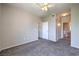 Neutral bedroom featuring plush carpet, ceiling fan, and connecting bathroom at 9050 W Warm Springs Rd # 2062, Las Vegas, NV 89148