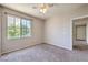 Cozy bedroom features neutral walls, a ceiling fan, and a window with a peaceful view at 9050 W Warm Springs Rd # 2062, Las Vegas, NV 89148