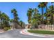 Entryway to 'The Falls' community lined with palm trees and manicured landscaping at 9050 W Warm Springs Rd # 2062, Las Vegas, NV 89148