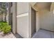 Close-up view of the condo entrance with a traditional door, exterior lighting, and stone accents at 9050 W Warm Springs Rd # 2062, Las Vegas, NV 89148