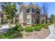 Well-maintained condo exterior with lush greenery, mature trees, and gravel landscaping at 9050 W Warm Springs Rd # 2062, Las Vegas, NV 89148