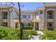Charming condo building featuring stucco facade, tile roof, manicured landscaping, and private balconies at 9050 W Warm Springs Rd # 2062, Las Vegas, NV 89148