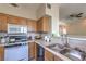 Bright kitchen with wood cabinets, countertops, and a double sink at 9050 W Warm Springs Rd # 2062, Las Vegas, NV 89148