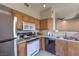 Kitchen with stainless steel refrigerator and light wood cabinets at 9050 W Warm Springs Rd # 2062, Las Vegas, NV 89148