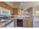 Eat-in kitchen with wood cabinets that opens to a living area at 9050 W Warm Springs Rd # 2062, Las Vegas, NV 89148