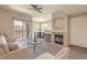 Comfortable living room featuring a fireplace, balcony access, and a breakfast nook with natural light at 9050 W Warm Springs Rd # 2062, Las Vegas, NV 89148