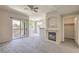 Bright living room featuring a fireplace, balcony access, and neutral carpeting at 9050 W Warm Springs Rd # 2062, Las Vegas, NV 89148