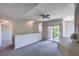 Neutral living room with a balcony and view of trees at 9050 W Warm Springs Rd # 2062, Las Vegas, NV 89148