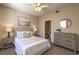 Serene main bedroom featuring soft lighting, dresser, and en-suite bathroom access at 9050 W Warm Springs Rd # 2062, Las Vegas, NV 89148