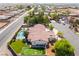 Expansive desert home featuring a pool, putting green, grassy yard, and mountain views in a quiet neighborhood at 9385 Mohawk St, Las Vegas, NV 89139