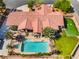 Luxury home featuring a sparkling pool, lush landscaping, covered patio, and a putting green for entertaining at 9385 Mohawk St, Las Vegas, NV 89139
