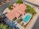 Luxury home featuring a sparkling pool, lush landscaping, covered patio, and a putting green for recreation at 9385 Mohawk St, Las Vegas, NV 89139