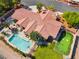 Upscale home showcasing a sparkling pool, lush landscaping, covered patio, and putting green for outdoor fun at 9385 Mohawk St, Las Vegas, NV 89139