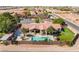 Desert home showcasing a sparkling pool, lush landscaping, covered patio, and a putting green for entertainment at 9385 Mohawk St, Las Vegas, NV 89139