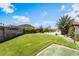 A lush lawn is framed by mature trees, complemented by a sparkling pool and patio seating at 9385 Mohawk St, Las Vegas, NV 89139