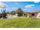 Expansive lawn with mature palm trees, pool, basketball hoop, and ample room for outdoor activities at 9385 Mohawk St, Las Vegas, NV 89139
