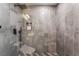 Modern bathroom featuring stylish gray tiling, mosaic floor accents, and a rainfall shower head at 9385 Mohawk St, Las Vegas, NV 89139