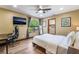 Comfortable bedroom with wood floors, ceiling fan, large window and walk in closet at 9385 Mohawk St, Las Vegas, NV 89139