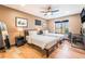 Cozy bedroom with two beds, wood floors, ceiling fan, desk area, and natural light at 9385 Mohawk St, Las Vegas, NV 89139
