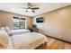 Bright bedroom featuring twin beds, wood floors, ceiling fan, and natural light at 9385 Mohawk St, Las Vegas, NV 89139