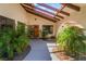 Arched front entrance to a home with desert landscaping and a skylight at 9385 Mohawk St, Las Vegas, NV 89139