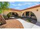 Arched entry to the home featuring desert landscaping and a walkway at 9385 Mohawk St, Las Vegas, NV 89139