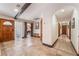 Inviting entryway with stone floors, wooden door, decorative accents, and a glimpse into the game room at 9385 Mohawk St, Las Vegas, NV 89139