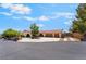 Wide shot of a home featuring mature trees, a spacious driveway, and a three-car garage at 9385 Mohawk St, Las Vegas, NV 89139