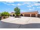 Wide shot of a home with three car garage, beautiful desert landscaping and large circular driveway at 9385 Mohawk St, Las Vegas, NV 89139