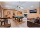 Entertaining game room featuring a pool table, fireplace, leather couch and wood flooring at 9385 Mohawk St, Las Vegas, NV 89139