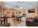 Entertaining game room featuring a pool table, fireplace, leather couch and wood flooring at 9385 Mohawk St, Las Vegas, NV 89139