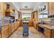 Bright kitchen with custom wood cabinets, stone countertops, stainless steel appliances and travertine flooring at 9385 Mohawk St, Las Vegas, NV 89139