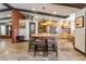 Spacious kitchen features brick island, counter seating, wood cabinets, and stainless steel appliances at 9385 Mohawk St, Las Vegas, NV 89139