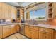 Close-up of bright kitchen with custom wood cabinets, stainless steel appliances, and stone countertops at 9385 Mohawk St, Las Vegas, NV 89139
