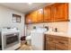 Functional laundry room with overhead cabinets, front-loading washer/dryer, and counter space at 9385 Mohawk St, Las Vegas, NV 89139