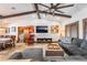 Comfortable living room with exposed beams, stone floors, plush seating, and view of the dining area at 9385 Mohawk St, Las Vegas, NV 89139